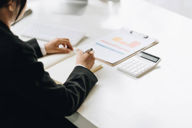 istock Asian Accountant checking tax and using calculator. Anti Bribery concept. 1404476968