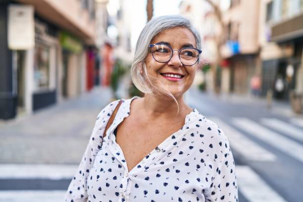 istock Middle age woman smiling confident standing at street 1404477018