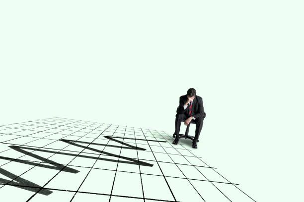 istock Dejected Man Sits In Chair On Declining Stock Chart 1404477623