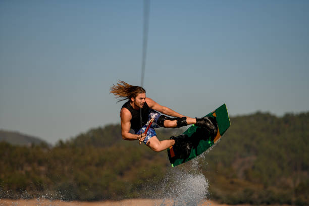 istock beautiful view of handsome healthy active man masterfully jumping on wakeboard 1404479172