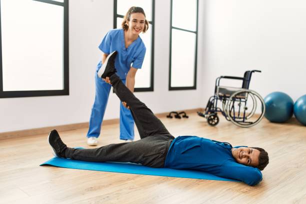 istock Young disabled man making mobility exercise at the clinic. 1404480533