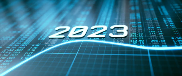 Year 2023 icon over a blue glowing line, financial figures spreadsheet and grid pattern. Close up, defocused, low angle composition.
