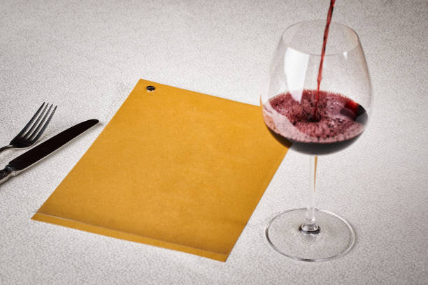 Food concept, top view, copy space. Glass of wine on a serving table with fork and knife. Writing space. Free space