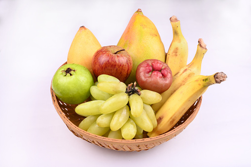 Healthy food background. Healthy vegan vegetarian food in paper bag and fruits on white, copy space, banner. Shopping food supermarket and clean fruits eating concept.