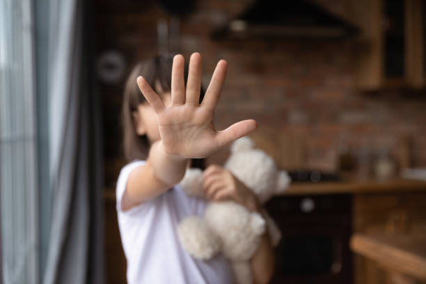 istock Scared little girl making no sign, showing hand stop gesture 1404482871