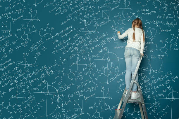 istock Portrait of happy kid girl resolving complex math problem on blue chalkboard. Kids math education concept. 1404483796