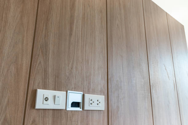 istock Power outlet on wooden Wall Background 1404485005