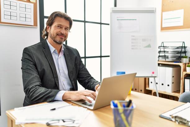 istock Middle age caucasian man smiling confident working at office 1404485114