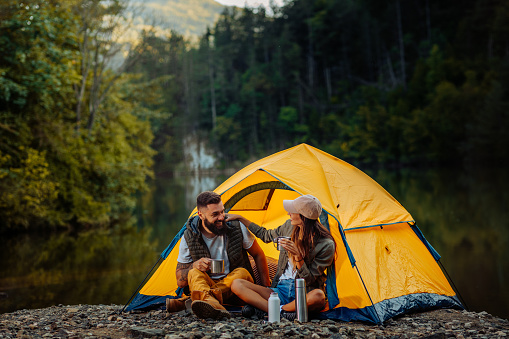 Couple sitting outside their tent and bonding