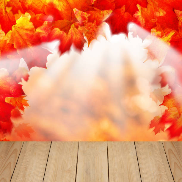 istock Autumn leaves and wooden background with copy space for text. 1404486301