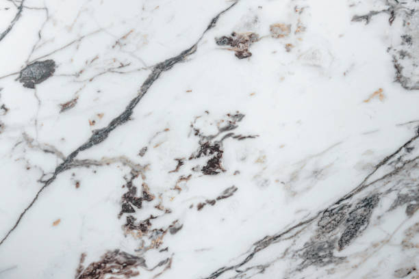 White marble stone texture top view. abstract pattern with grey and brown streaks for background or design art