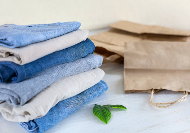 istock a stack of clothes in close-up and paper bags 1404487008