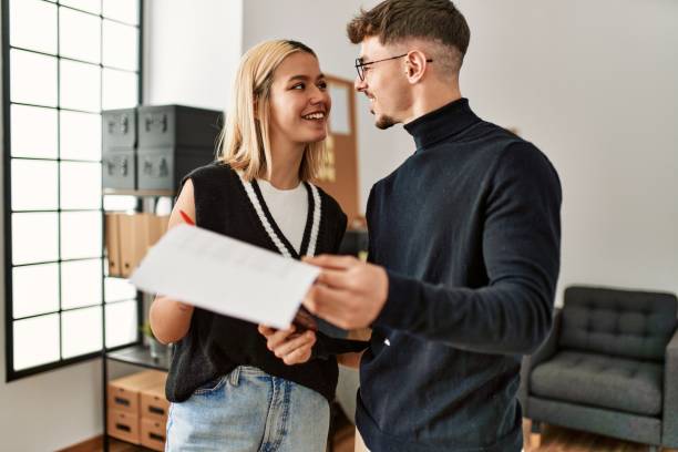 istock Two business workers smiling happy reading paperwork at the office. 1404488712