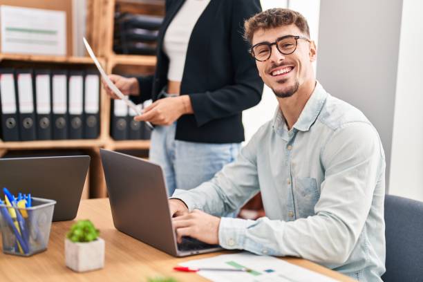 istock Young man and woman business workers using laptop working at office 1404488785