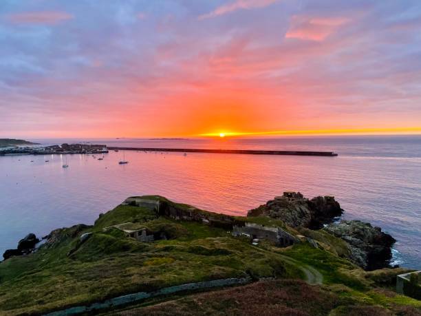 Sunset over Braye Harbour, Alderney Sunset over Braye Harbour, Alderney channel islands england stock pictures, royalty-free photos & images