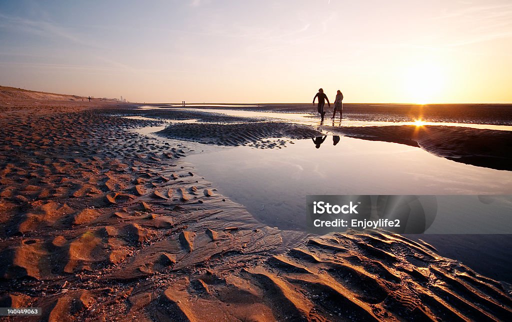 couple at the beach a couple at the beach on a beautiful night  Adult Stock Photo
