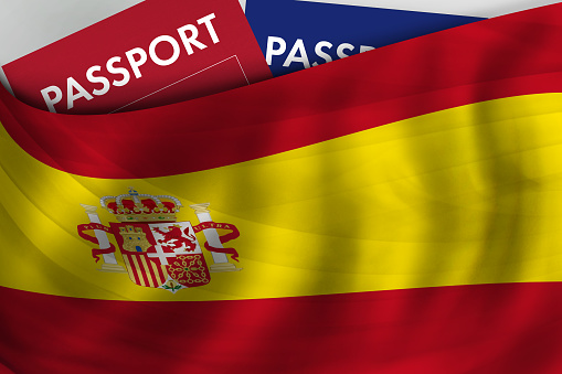 Spanish flag background and passport of Spain. Citizenship, official legal immigration, visa, business and travel concept.