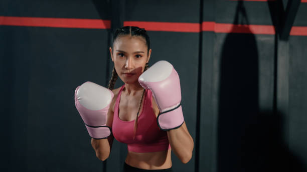 istock Young Asian Woman Warming up Before a Boxing Session. 1404492094