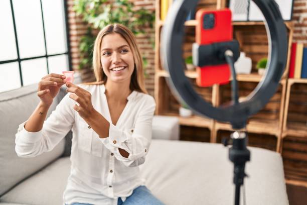 istock Young hispanic woman recording menstrual cup tutorial video at home 1404493466