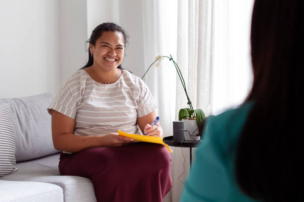 Encouraging therapist talking with female patient stock photo