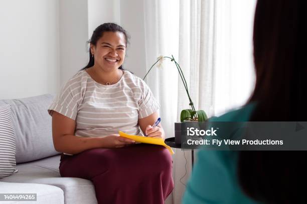 Encouraging Therapist Talking With Female Patient Stock Photo - Download Image Now - Mental Health Professional, Social Worker, Mental Health