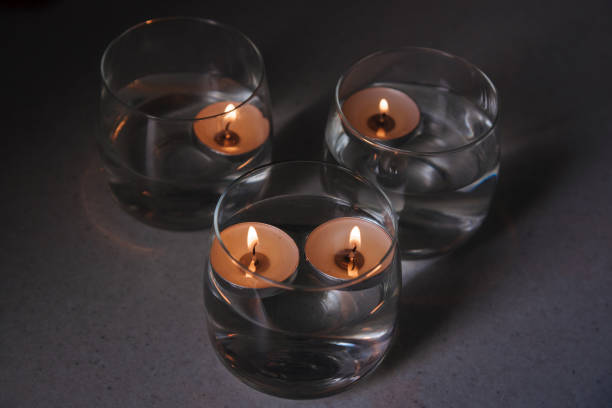 istock lit candles on water in candlesticks 1404494983