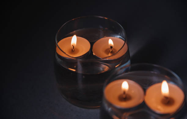 istock lit candles on water in candlesticks 1404494994