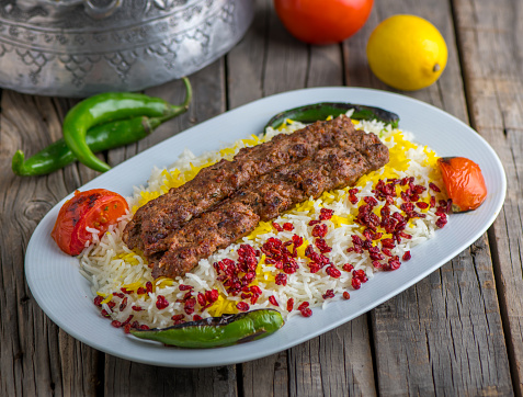 chelo kebab biryani served in dish side view on wooden table background