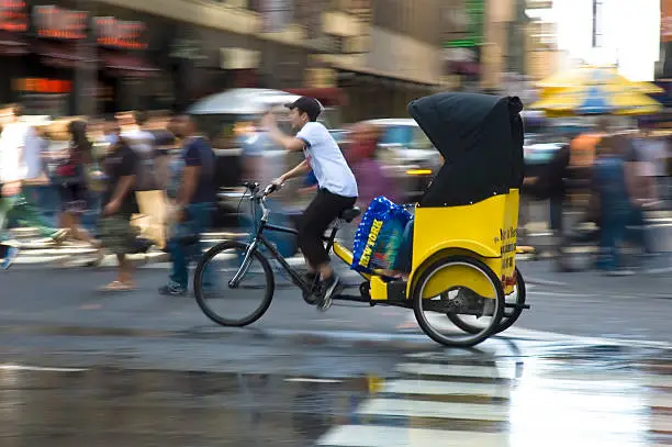 Pedicab with shopper on a wet Manhattan street
