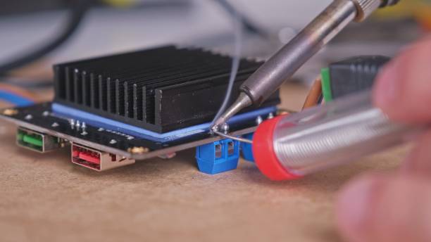 Skilled Caucasian Male Electrical Engineer Technician Soldering Digital Electronics Circuit Board Exercising Right To Repair
