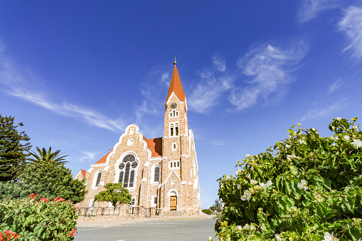 This Lutheran church was designed by Gottlieb Redecker and built with quartz sandstone in the thick of the wars the German empire was fighting with the Khoikhoi, Herero and Owambo peoples. Building started on 11 August 1907 and was completed in October 1910. The church has neo-Romanesque, art nouveau and Gothic revival architecture.
