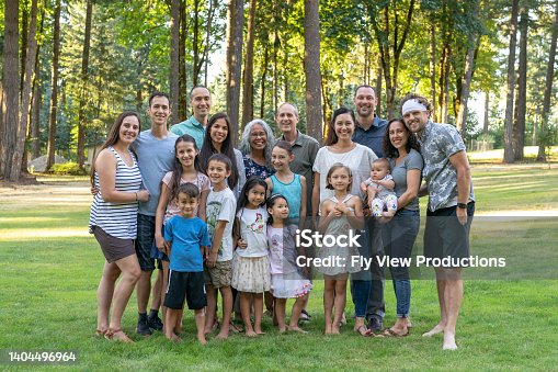 istock Multi-generation family celebrating reunion together outdoors 1404496964