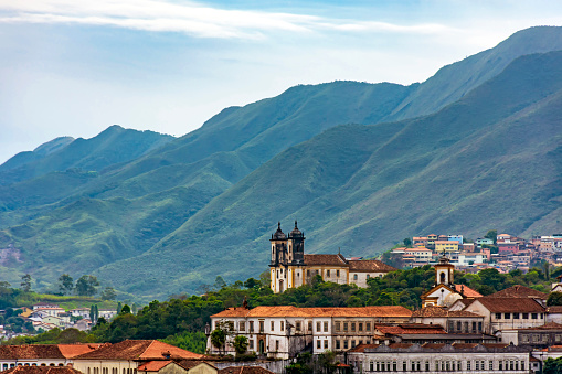 Curches, houses and mountains of Ouro Preto city in Minas Gerais with its colonial-style houses and churches and the mountains in the background