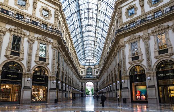 Milan, Italy: Milano Gallery Vittorio Emanuele II - shopping mall Milan, Italy - June 22, 2022: Prada and Louis Vuitton brand boutique shop in Milano Gallery Vittorio Emanuele II - shopping mall milan fashion week stock pictures, royalty-free photos & images