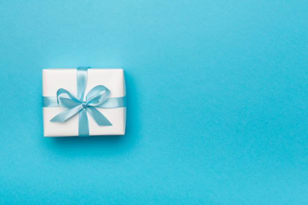 istock White gift box on color background, top view 1404499339