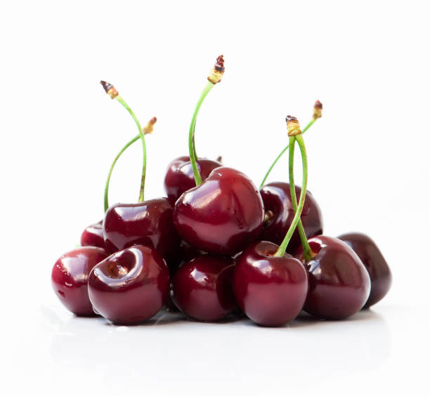 red cherries red cherries on a white background cherry stock pictures, royalty-free photos & images