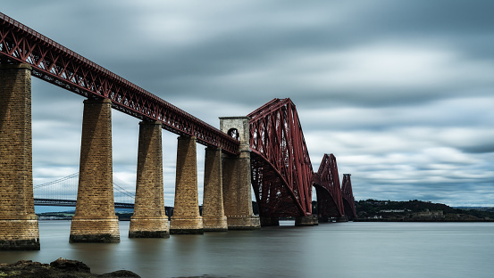 Queensferry, United Kingdom - 21 June, 2022: view of the historic cantilver railway Forth Bridge across the Firth of Forth in Scoltand