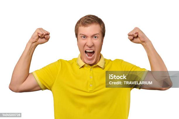 Funny Young Man In Casual Yellow Tshirt Raising Hands And Rejoicing Of Success Isolated Background Stock Photo - Download Image Now