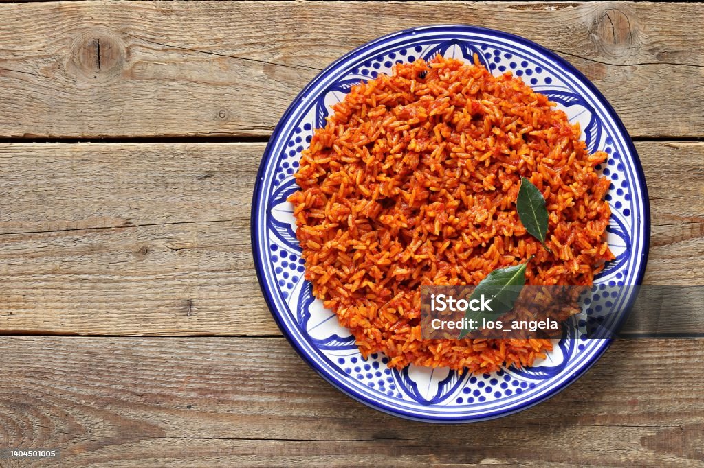 Jollof Rice. Jollof Rice. Traditional Nigerian dish. Flat layot Rice - Food Staple Stock Photo