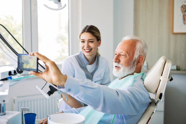 istock Smiling mature man at dentist making selfie 1404504220