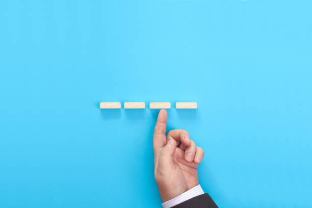 istock Hand of a businessman supporting wooden step 1404504295