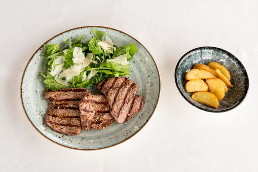 Grilled steak with fries and green salad