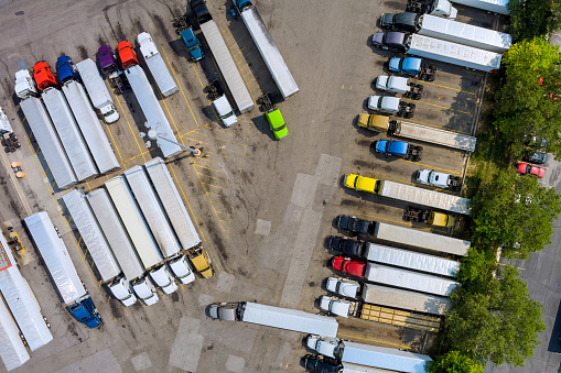 A top view at the rest area of a can see truck trucks standing on the highway