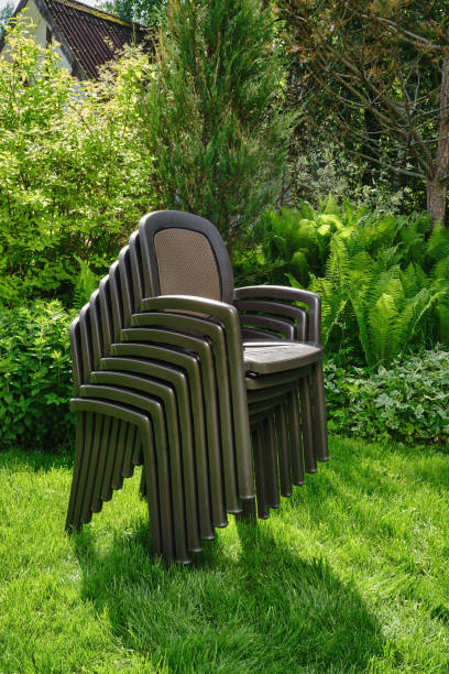 istock Plastic chairs in ornamental garden background. Selective focus. 1404509722