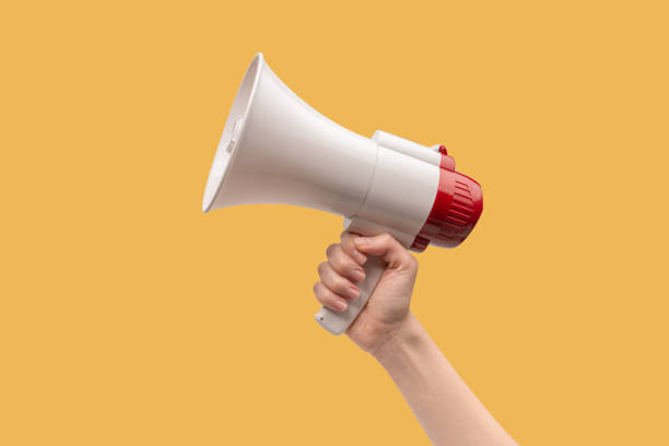 istock Megaphone in woman hands on a white background. 1404512366