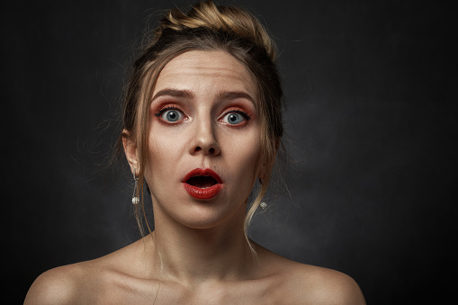 Beautiful young woman wearing casual winter sweater standing over isolated background crazy and mad shouting and yelling with aggressive expression and arms raised. Frustration concept.