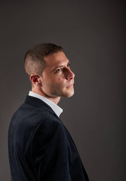 istock A young man wearing a white shirt and a black jacket 1404515175