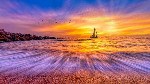 Sunset Sailboat Ocean Sun Rays 15:9 High Resolution stock photo