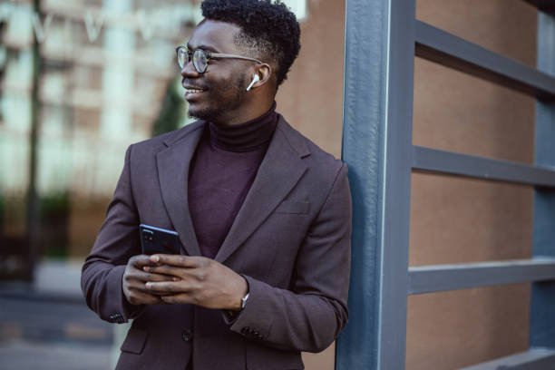 istock Young good looking African-American businessmen using smart phone 1404516358