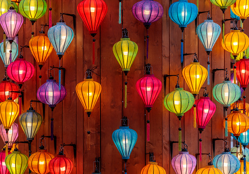 Glowing colorful lanterns on a wooden wall as a stage decoration at a festival in Yokohama, Japan.